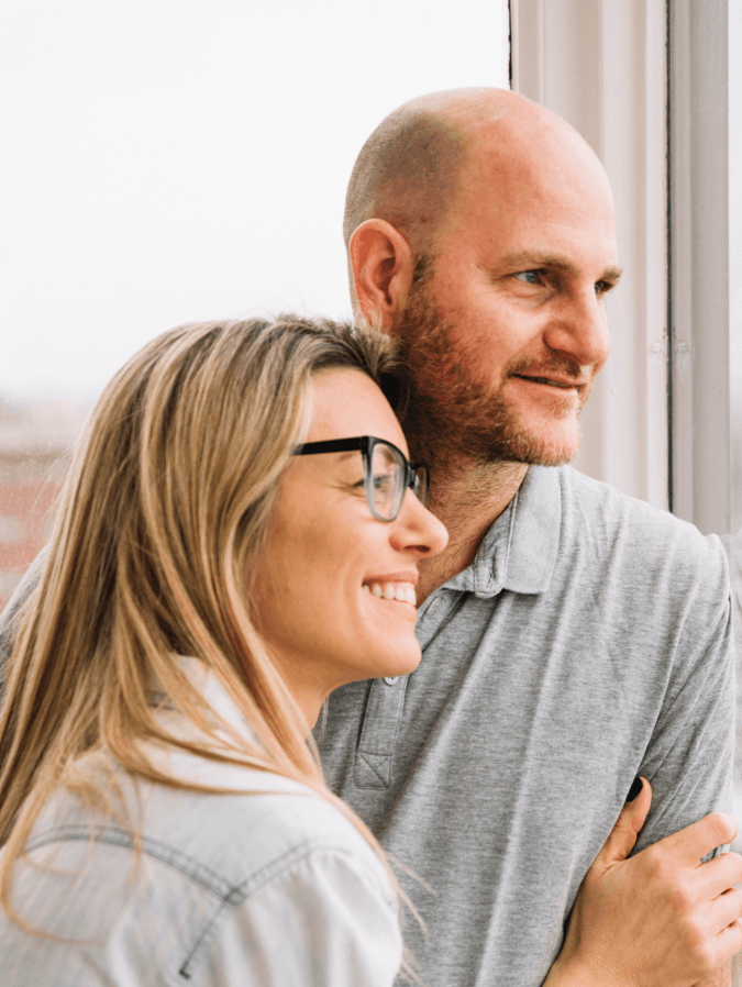 Happy couple looking out of the window